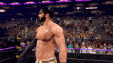 a man in a wrestling ring with a crowd behind him and a sign that says do n't say a word