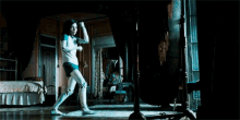 a woman in a white shirt is holding a sword in her hands