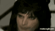 a close up of a person wearing a wig and a white hat .
