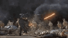 a group of people are standing in a dark room with a sword in the air .