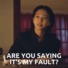 a woman in a black suit says are you saying it 's my fault