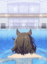 a woman in a bathing suit is swimming in a pool with a goal in the background