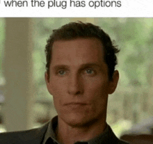 a man in a suit and tie is looking at the camera with a caption that says when the plug has options .