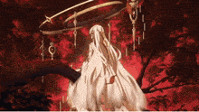 a woman in a white dress is standing in the woods