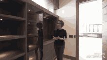 a woman standing in a room with the words made in animatica on the bottom right