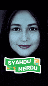 a woman wearing a hijab has a sticker on her face that says syahdu merdu