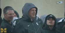 a group of people are watching a game on fox sports