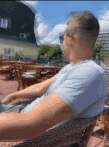 a man wearing sunglasses is sitting in a chair