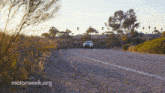 a car is driving down a road with motorweek.org written on the bottom right