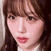 a close up of a girl 's face with a fringe