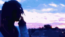 a blurry picture of a person looking out a window at a sunset