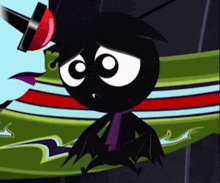 a black cartoon character with a red hat is sitting on a green and red striped surface .