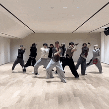 a group of people are dancing in a room and one of them has a bag that says ' coca cola ' on it
