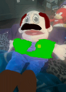 a stuffed animal with a mustache and green shirt
