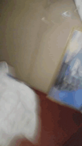 a close up of a person holding a piece of paper with a picture of a mountain on it