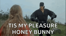 a man and a woman are standing next to each other in a field . the man is wearing a mask .