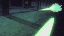a blurry picture of a green light coming out of a dark room