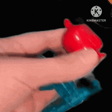 a person is holding a red and blue toy in their hands .