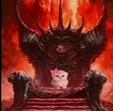 a white cat with a pink bow is sitting on a throne in front of a demon .