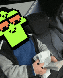 a person holding a bunch of money with a pixelated face in the background