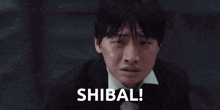a man in a tuxedo and bow tie is crying and the word shibal is next to him