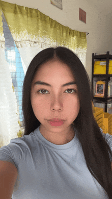 a girl taking a selfie in front of a window