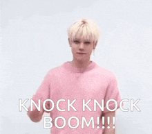 a man in a pink shirt holds up his fist and says " knock knock boom "