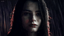 a close up of a woman 's face with rain drops on it and the name jenny on the bottom
