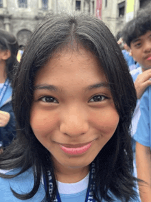 a girl with a lanyard around her neck that says ' philippines '