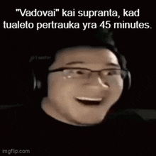 a man wearing glasses and headphones is smiling and laughing .