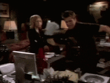 a blurry picture of a man and a woman in a room with a sign that says hollywood