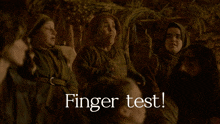 a group of people singing in a dark room with the words finger test above them