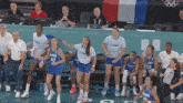 a group of female basketball players from france are dancing