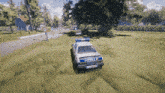 a police car is driving down a grassy street