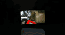 a black car is parked in a driveway in front of a house with a california tag