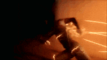 a person is being hit by a lightning bolt in the dark .