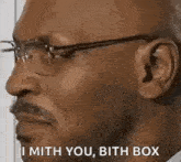a man wearing glasses and a mustache is talking to someone .