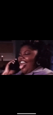 a woman is talking on a cell phone and laughing .