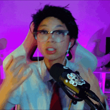 a woman wearing glasses and a shure microphone