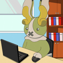 a cartoon bunny with a cross on its face is sitting at a desk with a laptop