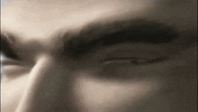 a close up of a man 's eyes with a ring in his nose