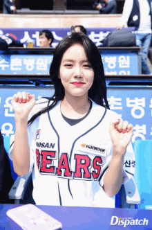 a woman wearing a bears baseball jersey with hankook written on the front