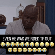 a man sitting in front of a sign that says ' even he was weirded tf out '
