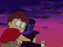 a boy in a red shirt is hugging a man in a black hat