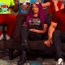 a woman with purple hair and a shirt that says feel the glow