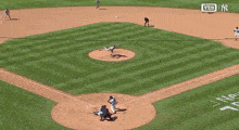 a baseball field with hyundai and geico ads