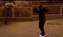 a person is riding a glow in the dark skateboard in the snow at night .