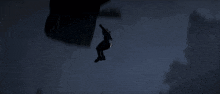 a person is flying through the air with a parachute at night