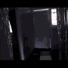 a person is carrying a large piece of cardboard in a doorway