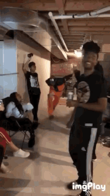 a group of people are dancing in a basement with the words imgplay at the bottom of the screen